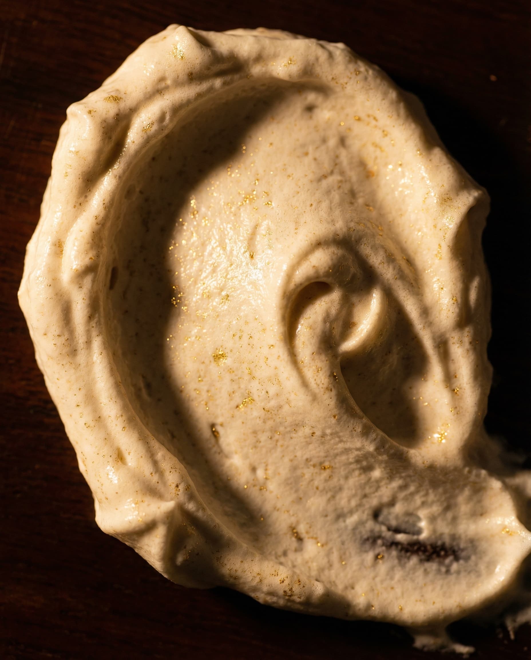 Rich cream texture with gold particles